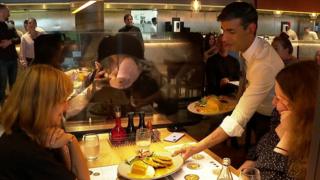 Rishi Sunak serving meals to customers