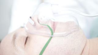 A stock of a patient wearing an oxygen mask