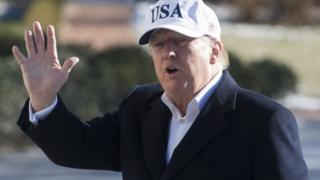 US President Donald Trump waves at journalists