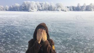 Woman protecting her face in the cold