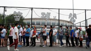 People queuing for a nucleic acid test on Wednesday - most people need a negative test before leaving the city, while others are banned entirely