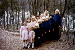 Children lined up in the compound of The Family