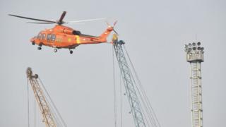 A Search and rescue helicopter flies during an operation for the ill-fated Lion Air flight