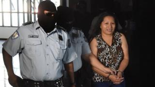 Teodora del Carmen Vasquez (R) is escorted as she arrives at the Isidro Menendez Judicial Center to attend a hearing to review her 2008 sentence -handed down under draconian anti-abortion laws after suffering a miscarriage- in San Salvador on December 8, 2017.