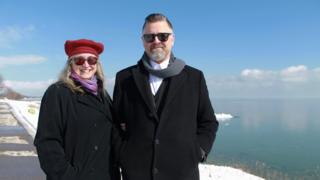 Tina and Jason Prigge stand in front of Lake Michigan