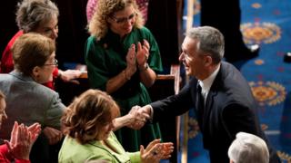 Jens Stoltenberg shakes hands with lawmakers before delivering an address to a joint meeting of the US Congress, 3 April