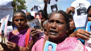 Sri Lankan mothers from the 'Missing Person's Parents' join others as they hold photographs during a protest outside the Jaffna Library in Jaffna,some 400 kilometres (250 miles) north of Colombo on September 2, 2016. UN Secretary-General Ban Ki-moon has toured Sri Lanka's former killing fields and met with war-battered minority Tamils after urging Colombo to reduce the army's presence to ease tensions following decades of ethnic bloodshed.The UN Secretary-General held talks with the main opposition politicians in the northern town of Jaffna, 400 kilometres (250 miles) north of Colombo on the final leg of the two day visit. / AFP / ISHARA S.KODIKARA (Photo credit should read ISHARA S.KODIKARA/AFP/Getty Images)