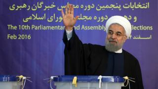 Iranian President Hassan Rouhani waves after voting in Tehran on 26 February 2016