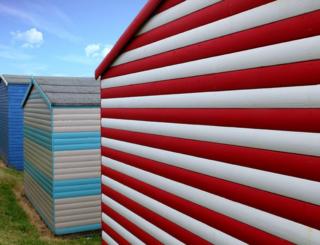 Red and blue coloured beach huts