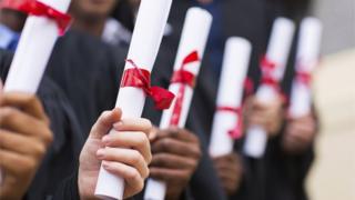 Students holding their scrolls