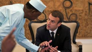 Chad"s president Idriss Deby Itno speaks with French President Emanuel Macron as they gather with Malian, Burkinabe, Nigerien and Mauritanian leaders for the G5 Sahel summit