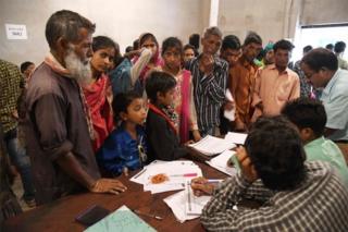 Assam State National Register of Citizens (NRC) officials check documents of Indian residents during AN appeal hearing against the non-inclusion of their names in the citizens register at a NRC office in Dhubri, some 261 kms from Guwahati