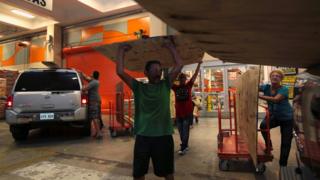 People buy materials at a hardware store in Puerto Rico