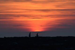 Silhouette of people at sunset