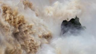 Huge volumes of water crash down the Barron Falls in Kuranda, Queensland