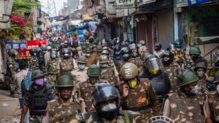 Indian policemen patrol amid a nationwide lockdown over the highly contagious novel coronavirus