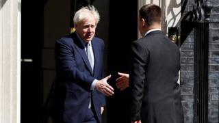 Boris Johnson shakes hands with Juri Ratas