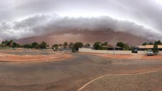 A storm creates a wall of dust above Port Hedland in Western Australia