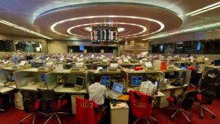 Traders work on the floor of the Hong Kong Stock Exchange