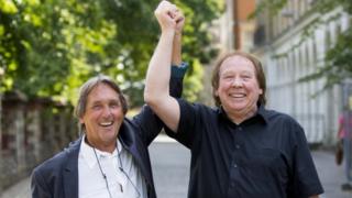 Leonard "Chip" Hawkes (left) and Richard Westwood, who were members of the 1960s pop group The Tremeloes, celebrate outside Reading Crown Court after being formally acquitted