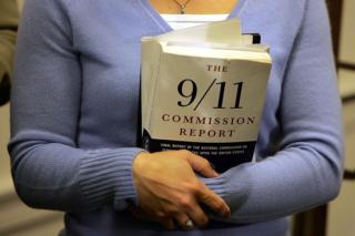 Carie Lemack, who lost her mother Judy Larocque in the 9/11 World Trade Center attack, holds a copy of the 9/11 Commision Report during a press conference November 30, 2004