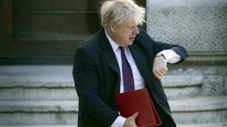 Boris Johnson checking his watch as he arrives for a cabinet meeting