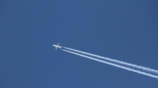 Imagem mostra avião voando, deixando rastro de fumaça no céu