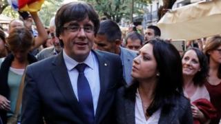 Sacked Catalan President Carles Puigdemont walks with his wife Marcela Topor during a walkabout in Girona, October 28, 2017
