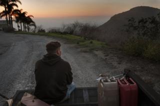 Kase Dietrich sits on the tailgate of Brayden's 91 Chevy pickup, near Oceanside, LA