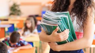 teacher holding books