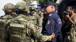 Marines escort Max Lorenzo Sedano after they took control in Acapulco on September 25, 2018.