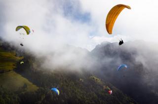 Paragliders, fly towards the landing area at Lake Geneva, Switzerland.