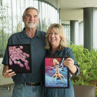 hollywood Tom holding an acinetobacter image, Steffanie holding an image of a phage