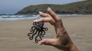A black Octopus Lego piece found washed up on a beach