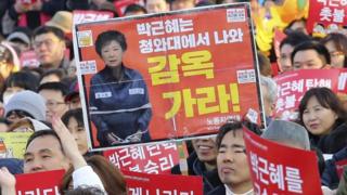 Anti-Park protesters in Seoul, 11 March. The sign reads Go to prison