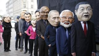 Protesters dressed like the G20 leaders return backstage from their appearance during a demonstration against the upcoming G20 economic summit during a protest march on July 2, 2017 in Hamburg, Germany