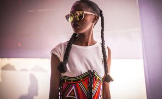 A model wearing a colourful and handcrafted accessory by fashion label Moyo By Bibi during Dakar Fashion Week in Dakar, Senegal