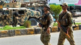 Afghan soldiers patrol outside a prison during an ongoing raid in Jalalabad on August 3, 2020