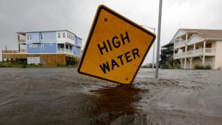 A "high water" sign is seen amid flooding in North Carolina