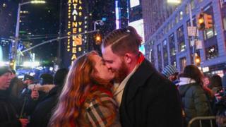 Matt Lutz and Olivia Shain, from Owensville Indiana, kiss amongst the ticker tape in New York