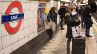 Passengers on the platform at Bank Underground station - some wearing masks