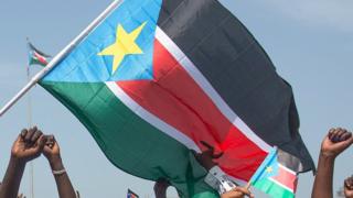 People waving the South Sudanese flag - 2015