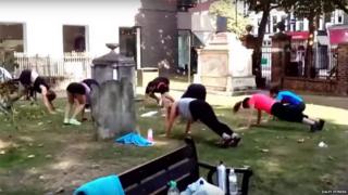 People exercising in graveyard
