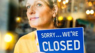 Woman with shop sign