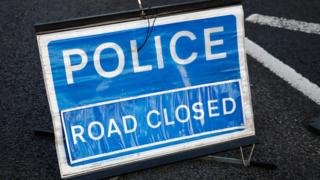Police road closed sign