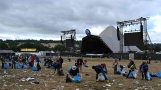 Litter pickers in front of the Pyramid stage
