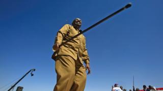 President Omar al-Bashir holding a stick in Khartoum, Sudan - Wednesday 9 January 2019