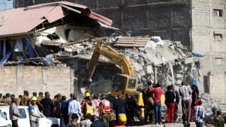 Rescue workers at the scene after a building collapsed in a residential area of Nairobi, 13 June 2017