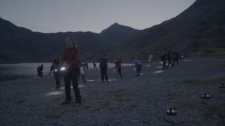 Green Space Dark Skies performers with lanterns at Llyn Llydaw on Snowdon