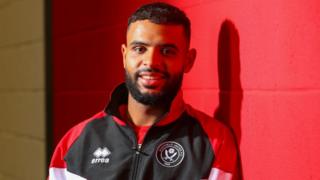 Anis Slimane poses in Sheffield United training kit